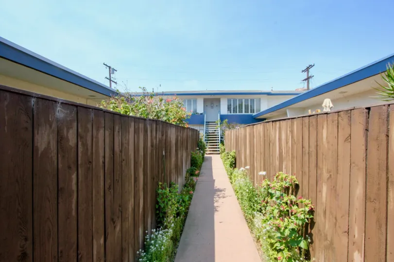 The building is shaped like a squared S. The two extensions extend into a covered patio circling around half the house. The second floor is smaller than the first, which allowed for several small balconies on one side of the house. This floor has roughly 