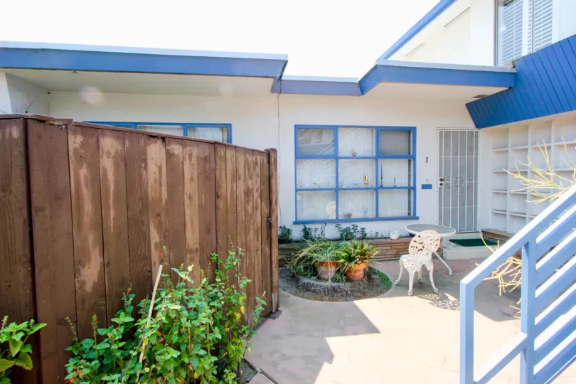 Blue roof, white walls and brown wood doors of Centinela Condos, Santa Monica, California