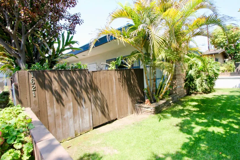 The closed front gate of Centinela Condos with number printed