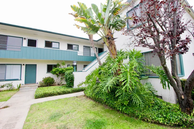 big white building with trees and lawn in California