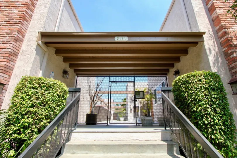 A sunny day in the Franklin & Colorado Townhouses house with children's playground and picnic tables