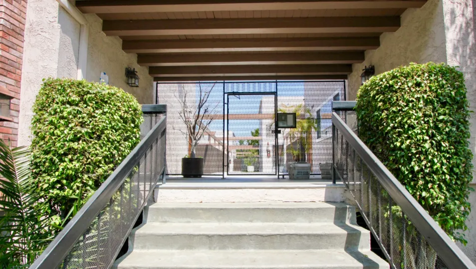 A rustic entrance to the Franklin & Colorado Townhouses with exposed beams as design on the ceiling.