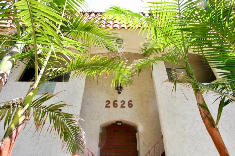 sunny day palm trees and beautiful house in Kansas Ave Condominiums