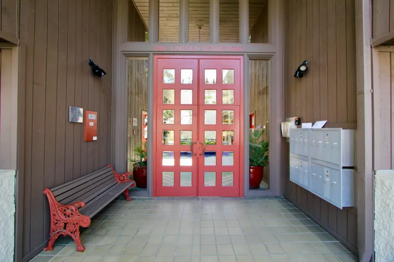 The front entrance of Lincoln Fountain Villas where residents pick up mail and relax on this custom painted bench.