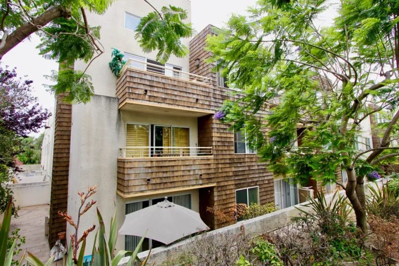 Trees in front of villa with 3 floors in Ocean Park Terrace community