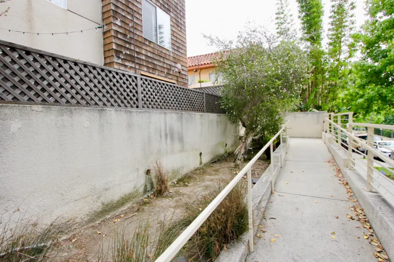 path outside a building in California with trees and plants