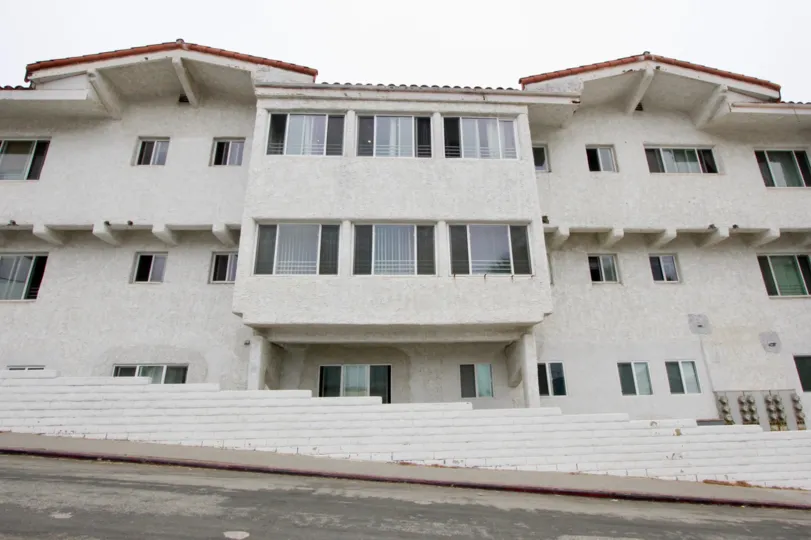 The Ocean View Santa Monica building looks tall with many open glass windows