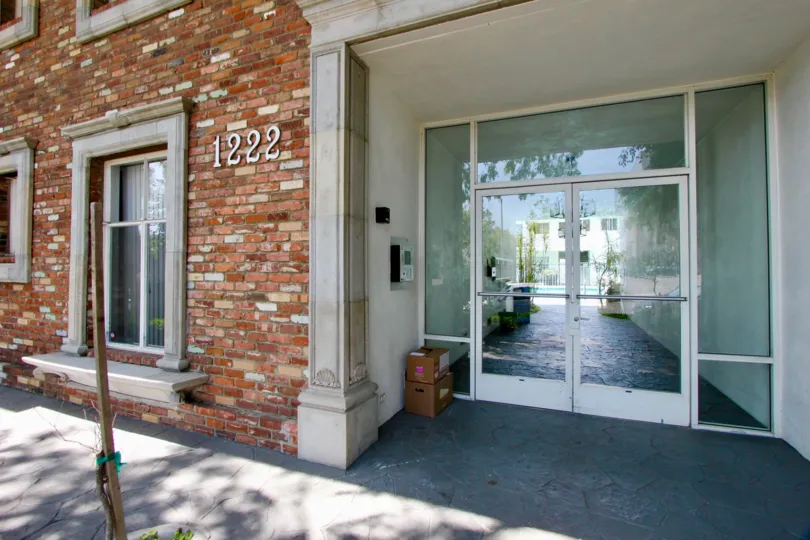 Glass doors leading to a lovely pool in a building with a pleasing brick facade