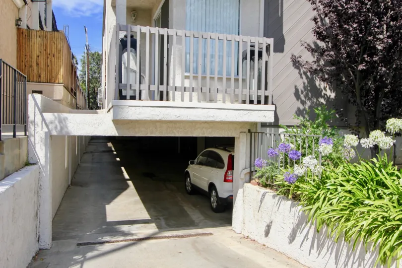 A parking area below a residential home in Rustic Glen community.