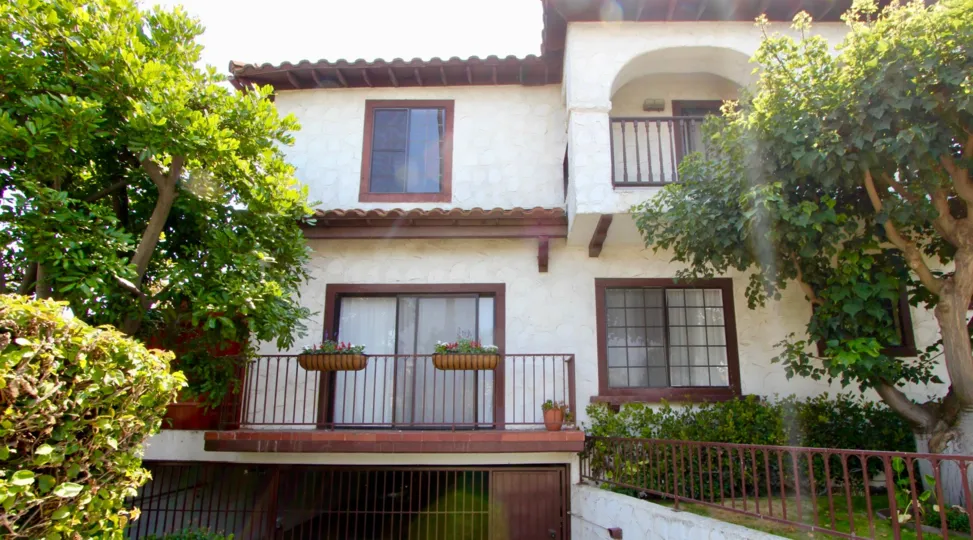 A HOUSE WITH TWO FLOORS AND ROOF TOP AT THE MORNING TIME SOME PLANTS ALSO NEAR TO THE HOUSE