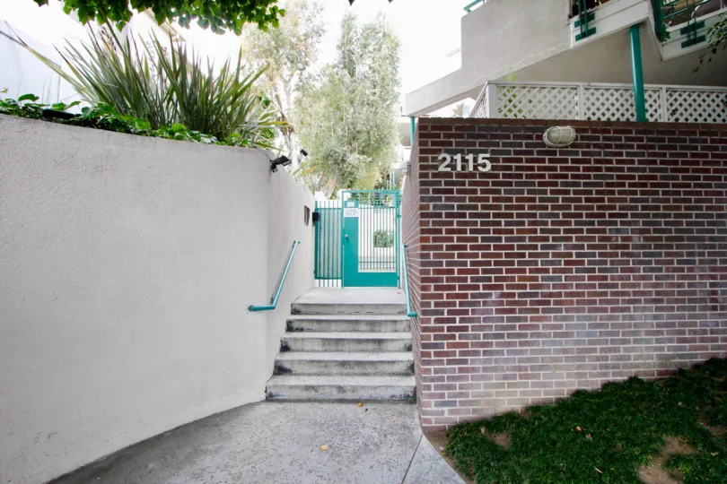 A short staircase in the Sea View Collection community with a red brick wall