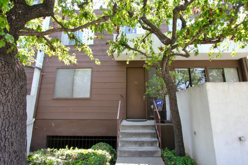 Brown and white walls with green trees in Seabreeze Townhomes, Santa Monica, California