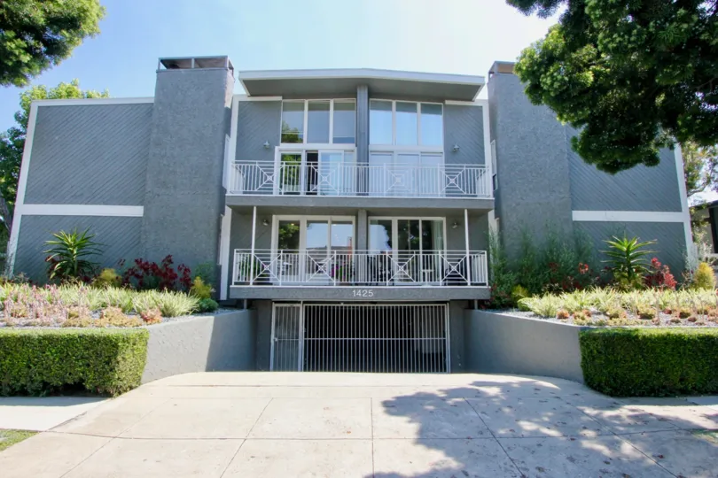4 seperate balconies and a white gate leading to underground parking at the Standford Gardens