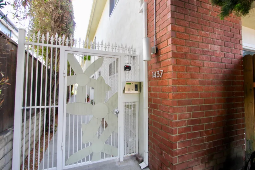 A sunny afternoon outside of the white gate at apartment 1437 at the Stanford Street Apartments in Santa Monica, California