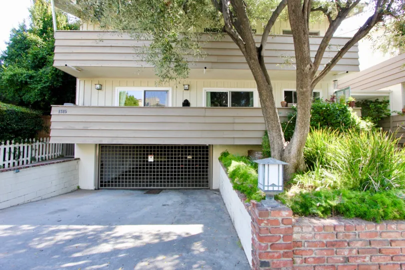 Modern condo at Stanford Street Condos with parking garage, sliding doors, and trees