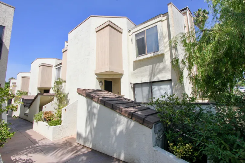 Sunny view of the Stanford Townhomes with nice shrubbery