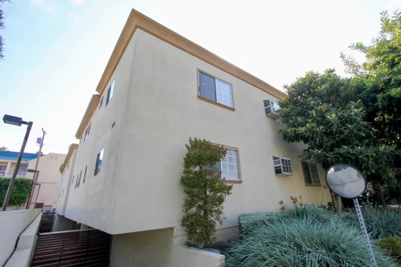 large brown building in California with trees and plants