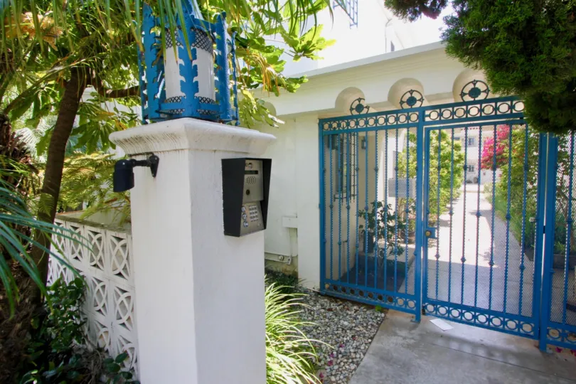 A blue gate entrance with a passcode at The Mediterranean in Santa Monica, CA