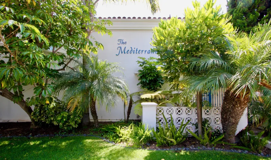 The white color building of The Mediterranean with so much of greenary around