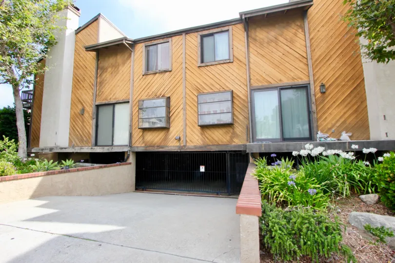 Modern two story duplex featuring diagonal wood clapboards in a chevron design with center underground garage.