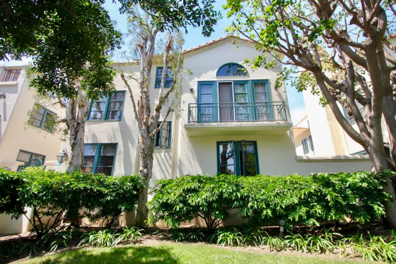 Big white building in santa monica with blue windows and many trees