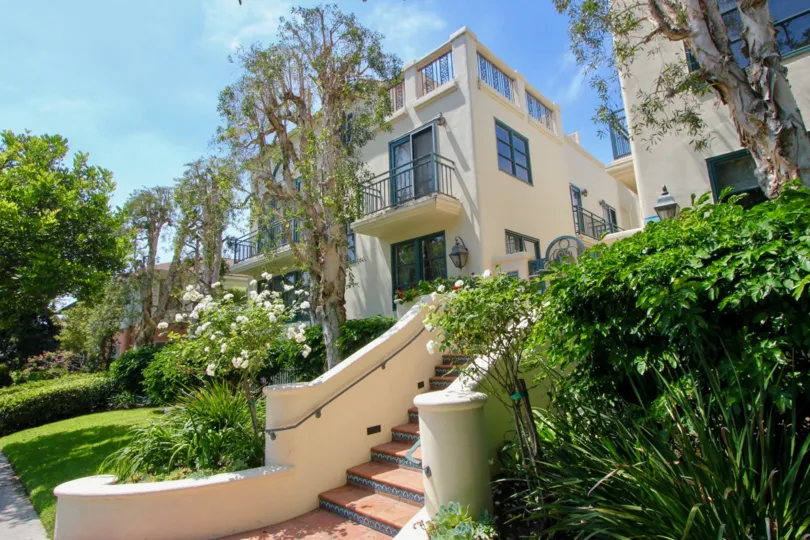Two, two storey apartment buildings with a stairway leading to a break between the buildings