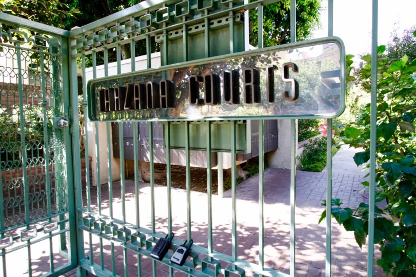 The name of Tarzana Court on the fence
