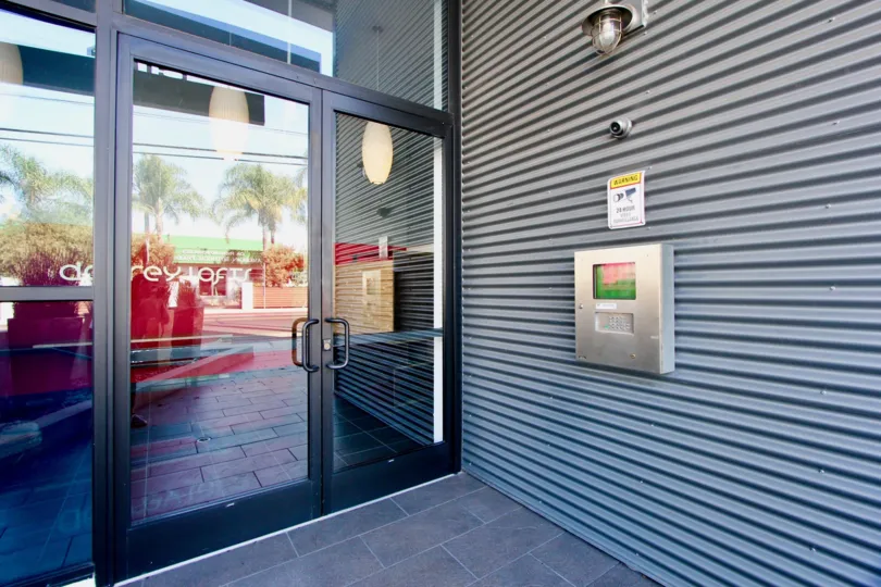 large walls with door of glass on entry of building in California
