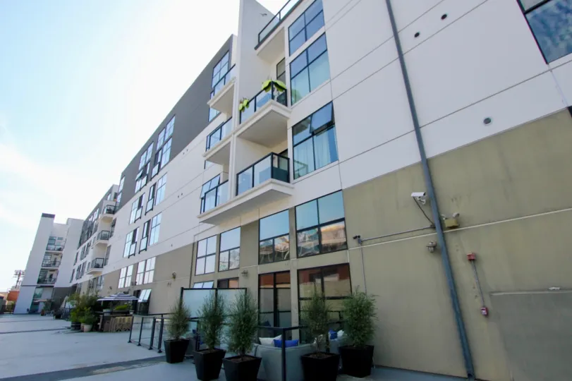 Four story modern, chic apartment complex with large windows and balconies in Venice.