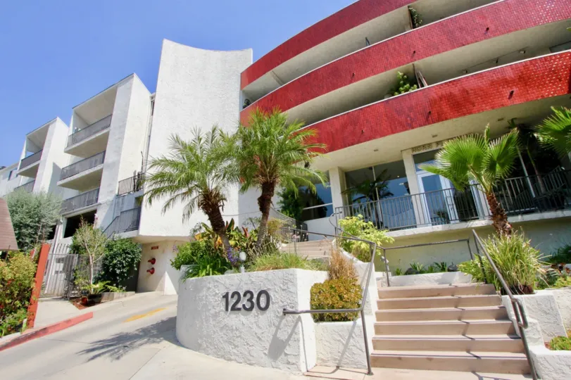 1230 Horn Plaza and her white and red walls with surrounding green plants, West Hollywood, California