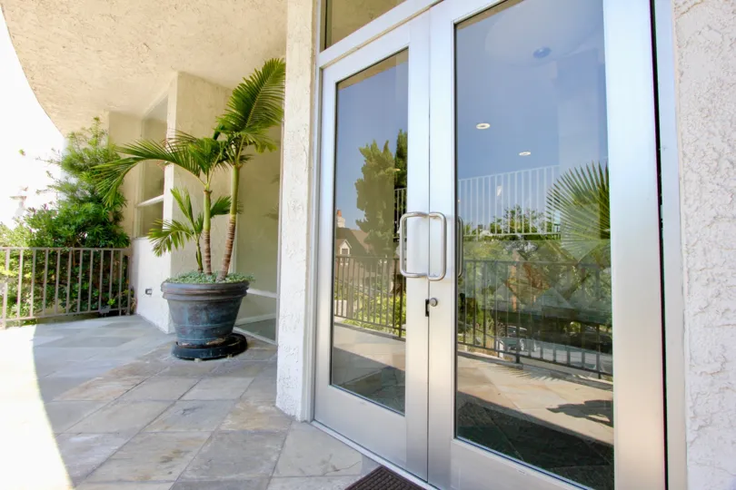 the front door of a house with glass door in horn plaza