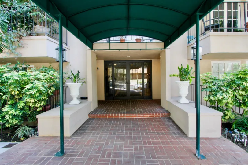 brick styled floor and green roofed walkway of Palm Hancock, West Hollywood, California