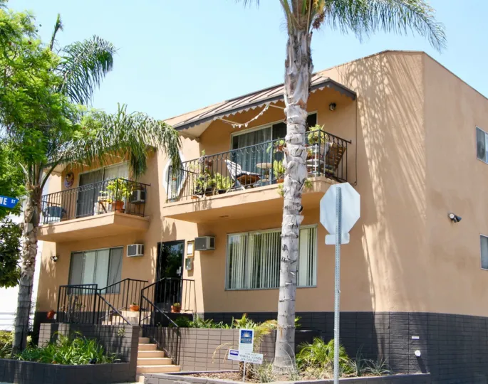 Simple and elegant homes surrounded by swaying palm trees in Romaine Terrace, West Hollywood, California.