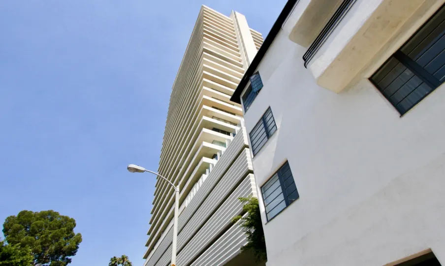 a big white building in sierra towers in a sunny day