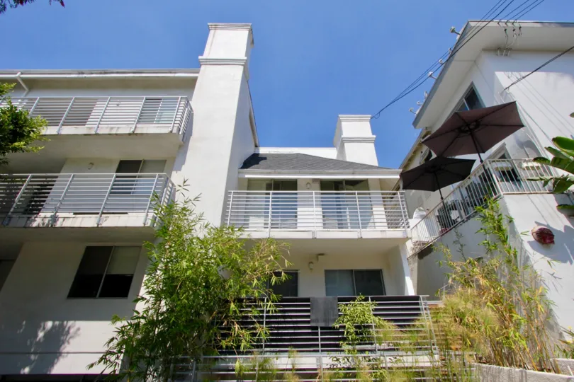 An apartment with balconies and two big umbrellas and bamboos in The Larrabee.