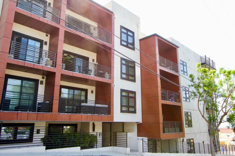 Upward and street view of the amazing red and creamy walls of The Shoreham Villas, West Hollywood, California