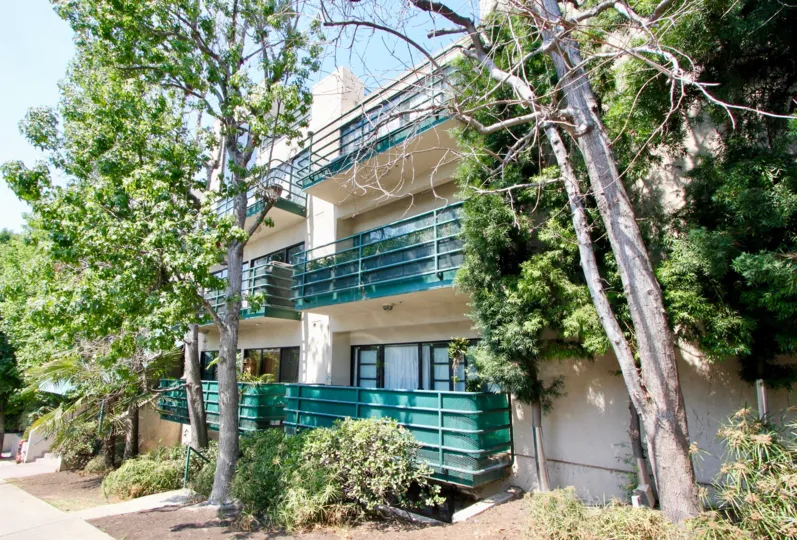 The turquoise balconies and lush trees at Vista Larrabee.