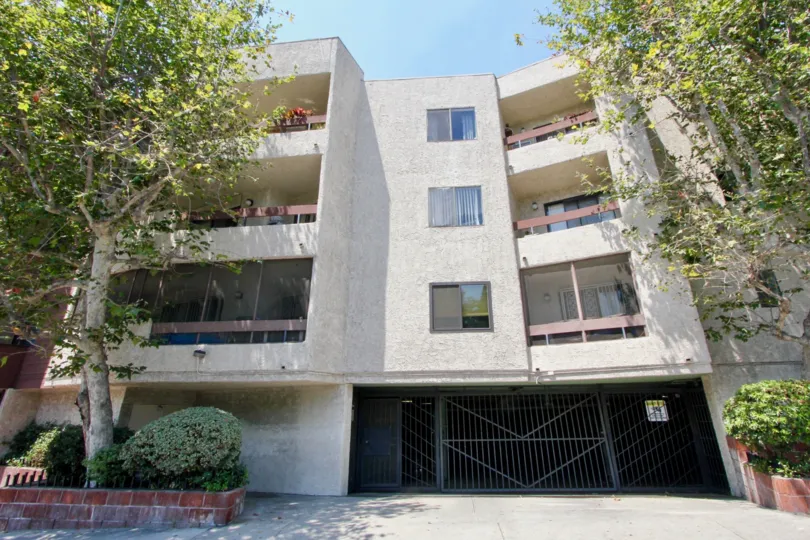 Parking entrance with trees at Vista Towers in sunny West Hollywood, CA.