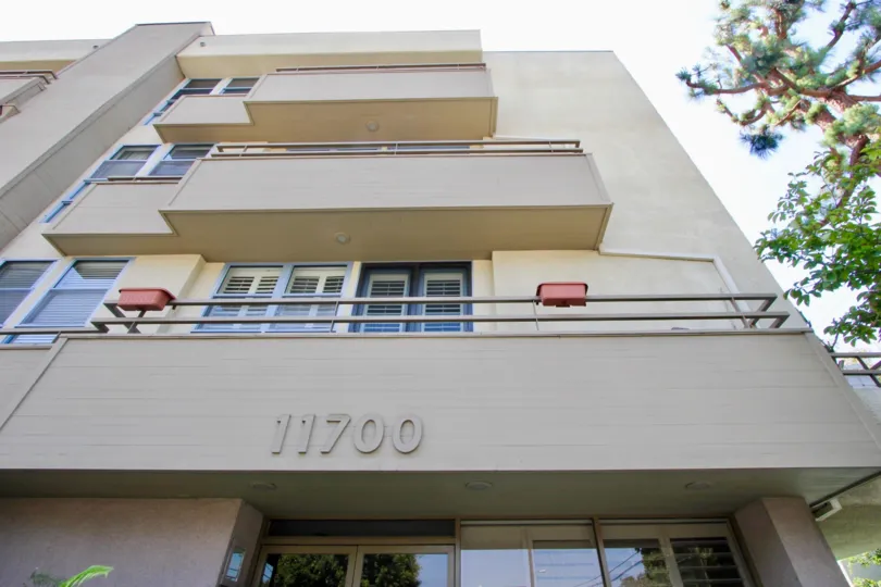 THE APARTMENTS WITH THREE FLOORS AND WITH WHITE COLOURS AND WINDOWS ALSO AVAILABLE AND A NEAR TREE ALSO AVAILABLE