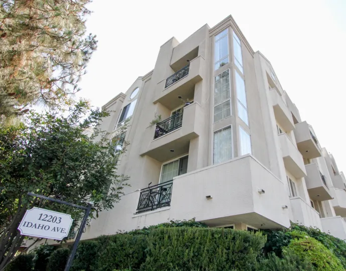 A sunny day in the 12203 Idaho with beautiful apartment and big tree infrond of apartment.