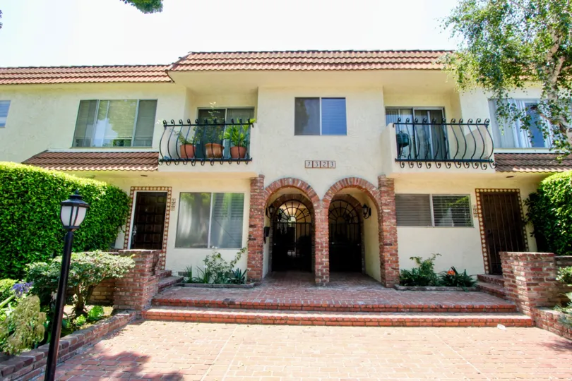 A sunny day at 1323 Carmelina, with Spanish-style flare and green hedges