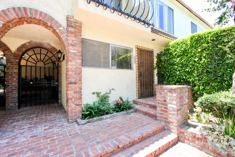A sunny porch with well kept bushes at 1323 Carmelina in West LA.