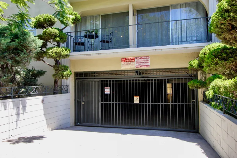 Daytime view of garage gate and trees at 1410 Bentley in sunny West LA, California.