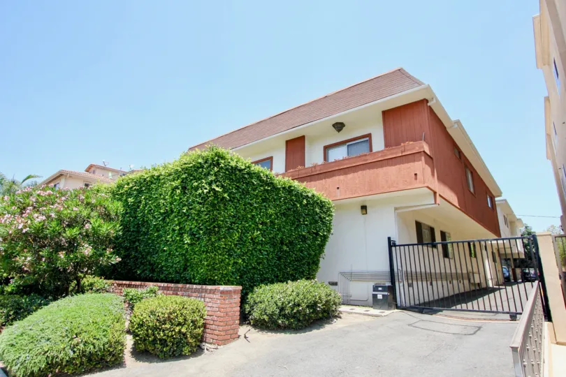 White and red walls of 1522 Centinela and her green plants, West La, California