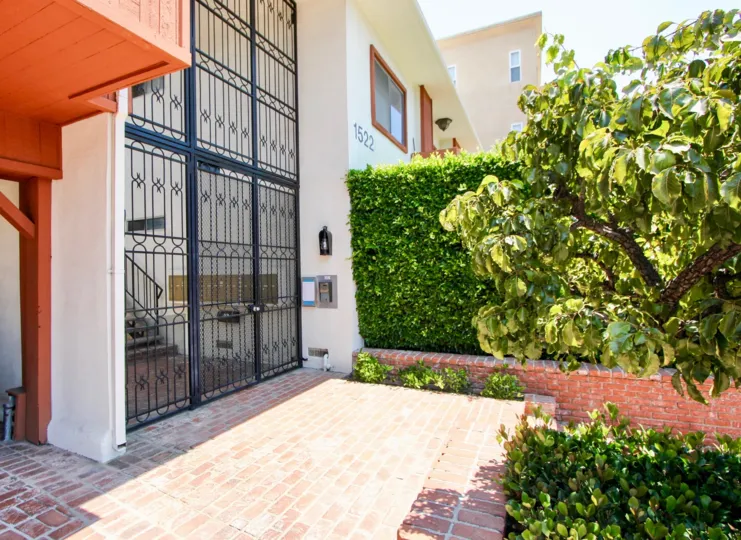 the front door of a house in 1522 Centinela with plants at the side