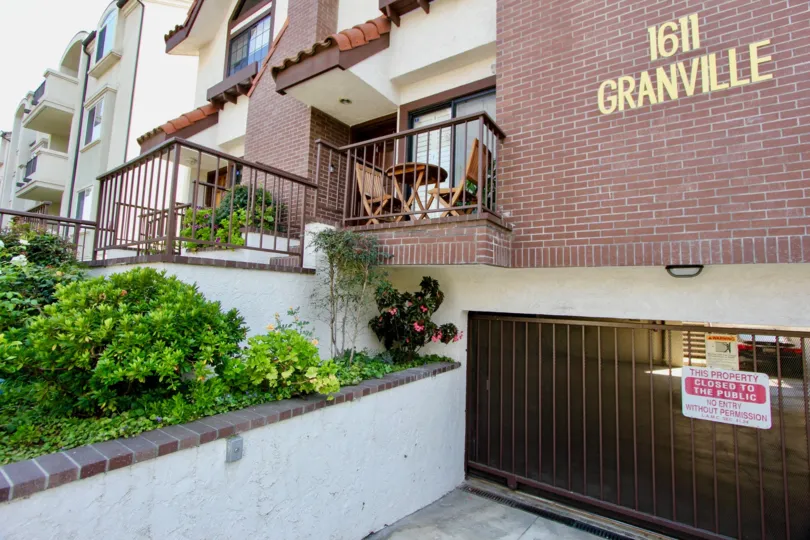 The closed gate and brick lined balconies at 1611 Granville.