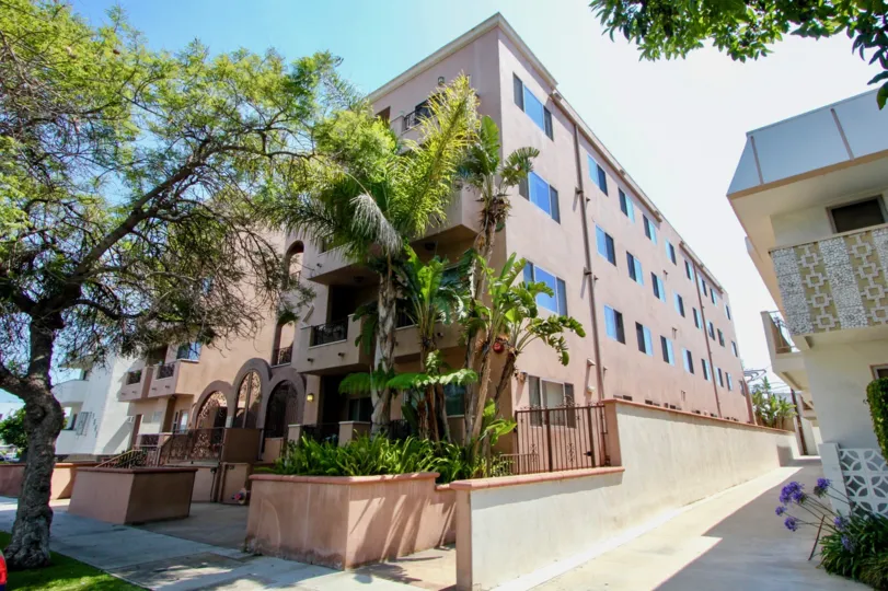 A large apartment building with an ornate security gate entrance