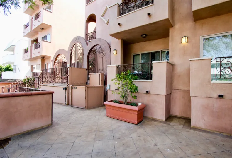Patio with planter and balconies on a sunny day in 1629 Armacost community.