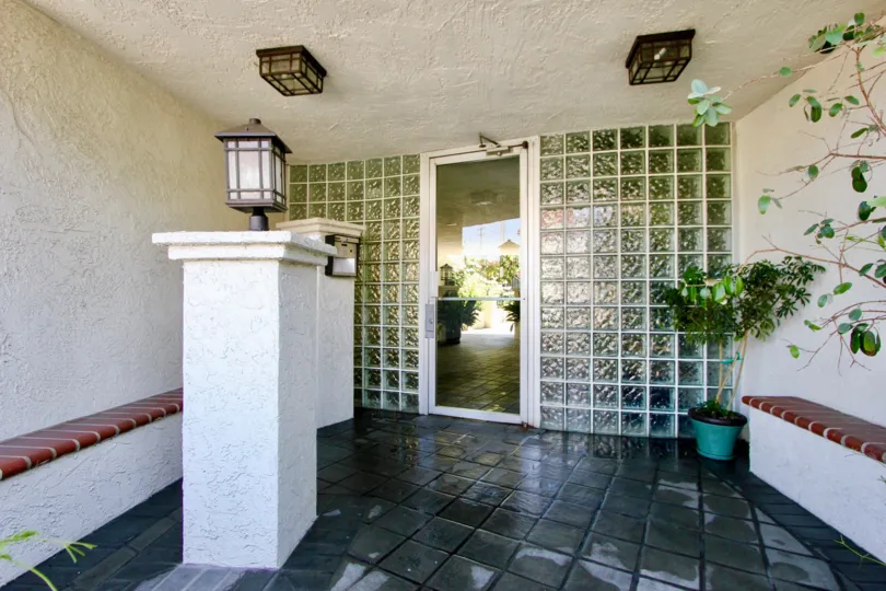 A covered patio area featuring an opaque glass wall in the 1741 Granville community of West LA, California.