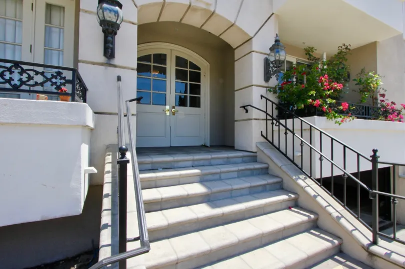View of front door and steps, balconies and plants at 1818 Colby in sunny West LA, California.